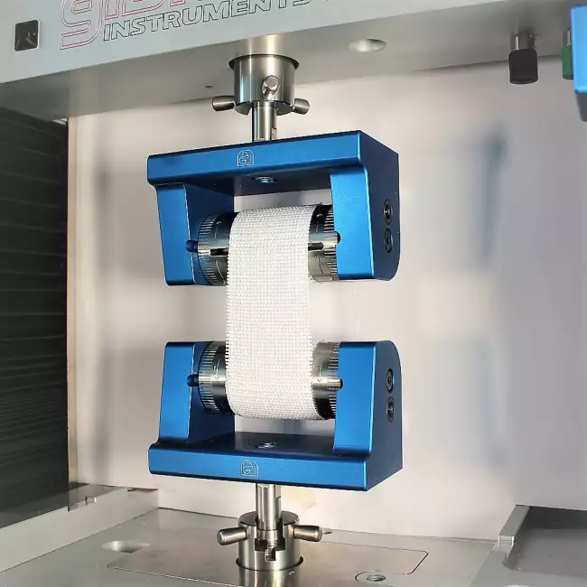 tensile tester grips: Tensor_Check: manual clamps for fabric testing. Example of tensile testing on fabric.