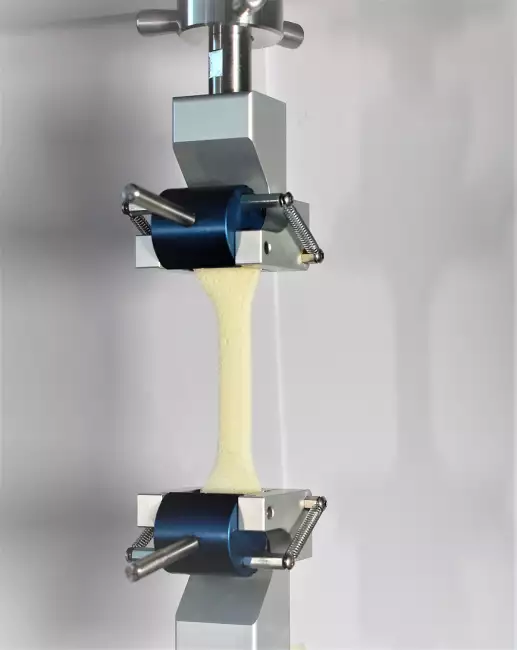 tensile tester grips: Tensor_Check: manual needle roller clamps. Tensile test according to ISO 37 type 1 on expanded specimen.